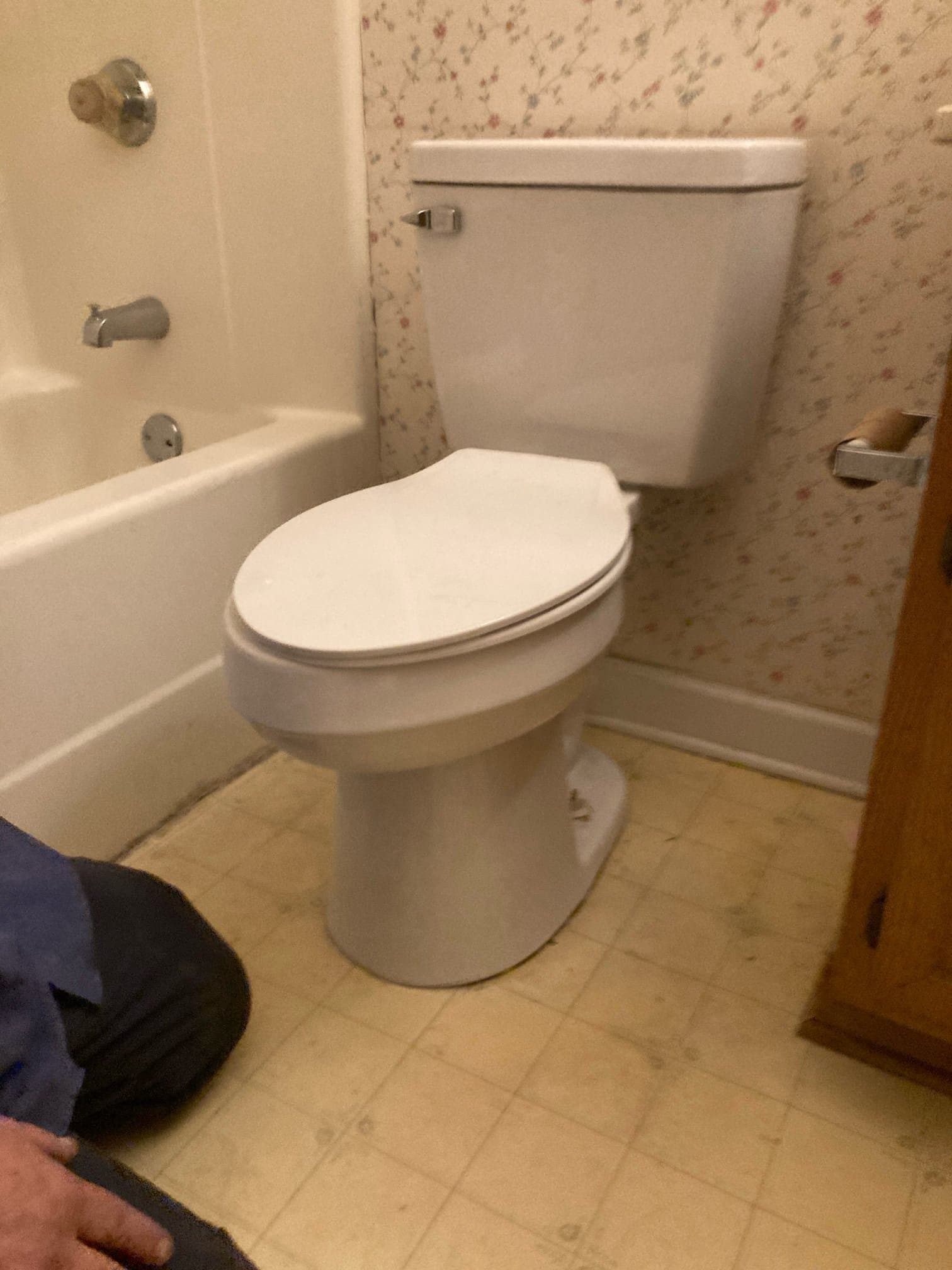 Pipe wrench, supply line, and seals laid out on a toilet during a replacement in Durham NC