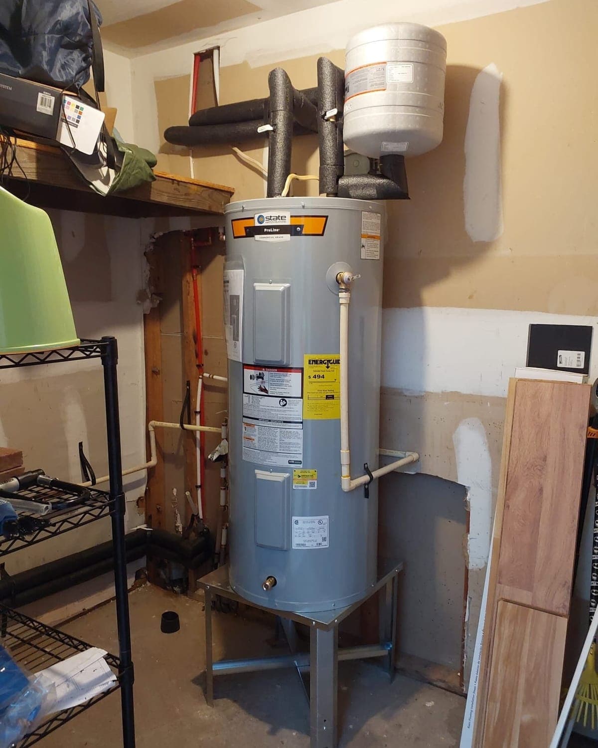 Newly installed tank water heater with expansion tank in a Durham utility room